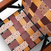 Close-up of a PARKIT woven chair seat with a cowboy and ranch-life inspired patterned design on a white background