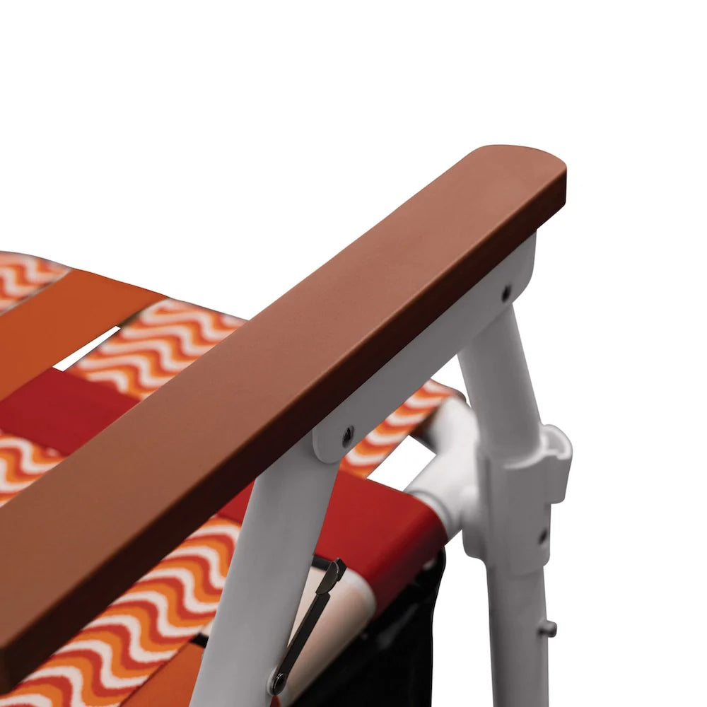 Close-up of a chair with a brown armrest and orange cream seat with wavy pattern on a white background