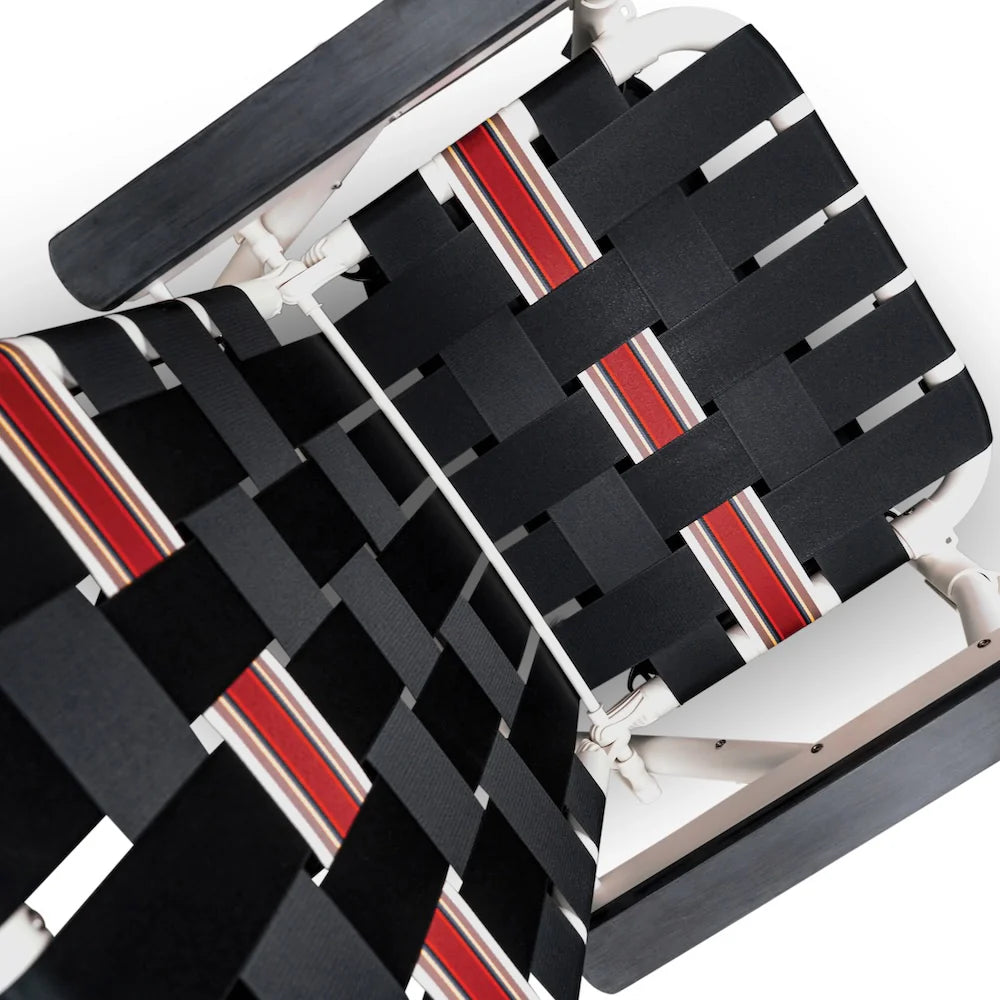 Black and red woven seat cover on a chair with a white background