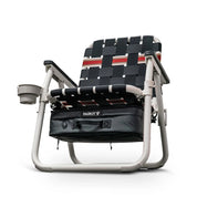 Foldable chair with woven seat and cup holder and cooler on a white background